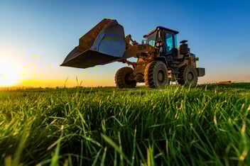 SEM wheel loader operating on a grassy site at sunrise, showcasing durability, performance and value-focused design.